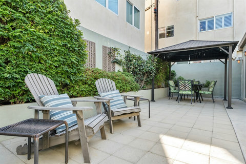 Relax & Recharge in the Backyard Lounge, dine, or sip your morning coffee in this peaceful backyard space. It’s the perfect spot to unwind after a day at the beach.