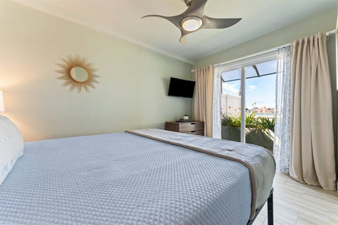 Relax in the Harbor-Facing King Bedroom This bright and airy room offers comfort, space, and a peaceful view of the water.