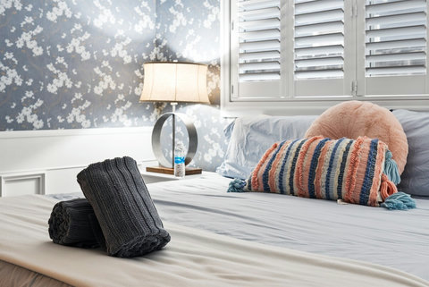 Ground-Floor Luxury Living: Relax in a King Bedroom with a Walk-In Closet, Electric Fireplace, and an Adjacent Full Bathroom with Shower/Tub