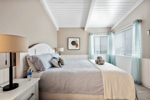 Your Seaside Sanctuary: Rest Well in the Spacious Master Bedroom with a King Bed, Mirrored Closets, Dresser, and Ocean Views.