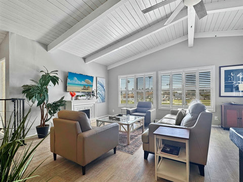 Serenity by the Sea: Relax on the Leather Sofa, Enjoy the Ambiance of the Electric Fireplace, and Admire the Beach Vistas.