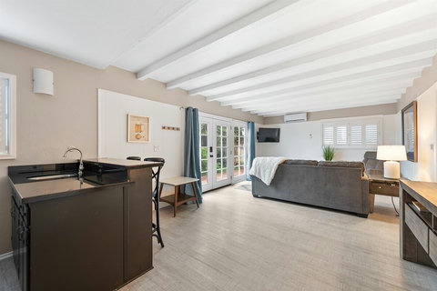 Your Family Oasis on the Ground Floor: Enjoy a Second Family Room with a Sofa Sleeper, 50" Smart TV, and a Thoughtful Coffee Bar.