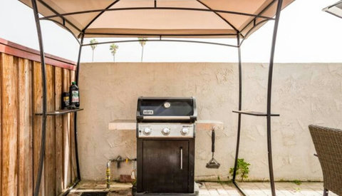 Back patio boasts a gas BBQ, seating for 8, and a pathway to the ocean, just steps from your door.