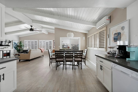 Fireside Comfort: Enjoy Plush Chairs by the Fireplace with Easy Access to the Open Dining Space.
