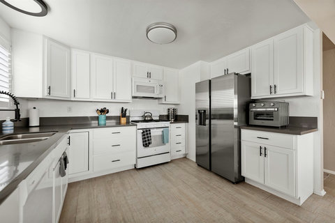 Chef's Paradise: Enjoy the Spacious, Fully Loaded Kitchen with Organized Spice and Knife Racks, Generous Cookware, and a Cozy Coffee Bar Right Next to the Dining Area.