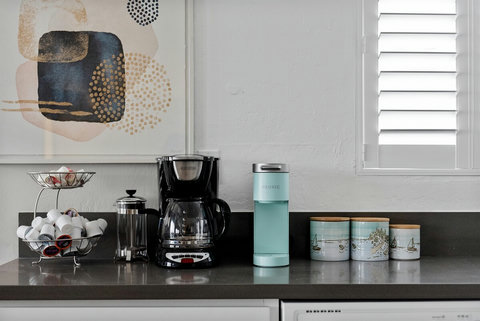 Gourmet Retreat: Discover a Newly Renovated, Fully Loaded Kitchen with Handy Spice and Knife Racks, a Bounty of Pots and Pans, and a Coffee Bar Just Steps from the Dining Area.