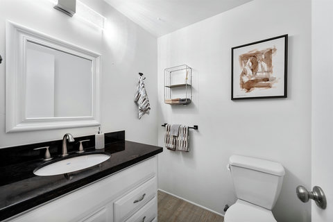 Powder Room Perfection: Easily Accessible for Guests Near the Open Living and Dining Area.