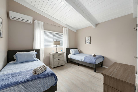 Your Home Away from Home: Relax in a Room with Two Twin Beds, Hotel-Style Linens, a Closet, and a Cozy Electric Fireplace
