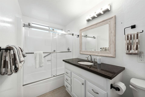 Pamper Yourself in Style: Our Full Bathroom Features a Shower/Tub Combination, Vanity with Hotel-Quality Towels, Toiletries, and a Hair Dryer for Your Convenience!