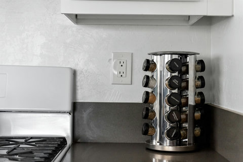 A Chef's Paradise: Our Kitchen is Fully Loaded with Amenities, Including a Spice Rack and Knife Block.