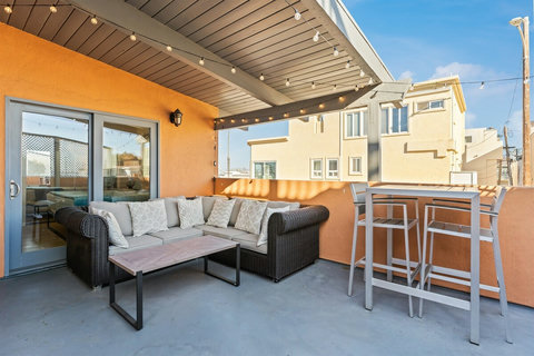 Rear Patio Step out onto the spacious rear patio, where you'll find lounge seating, a dining table, and a BBQ grill perfect for outdoor gatherings and late-night s'mores by the firepit.