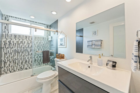 Main Bathroom Off Hallway Conveniently located, the main hallway bathroom features a shower/tub combination and thoughtful touches, perfect for families or groups.