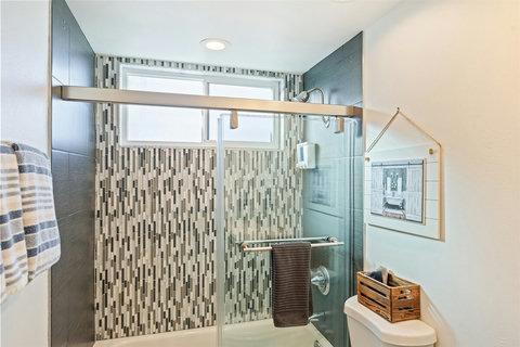 Main Bathroom Off Hallway Conveniently located, the main hallway bathroom features a shower/tub combination and thoughtful touches, perfect for families or groups.