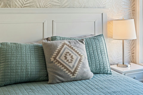 Queen Bedroom Charming and comfortable, the queen bedroom is ideal for restful nights and features a Smart TV, ample storage, and soft, inviting décor.