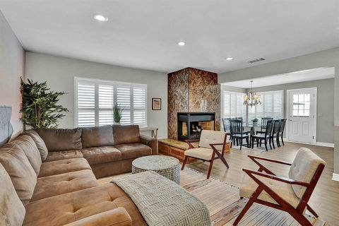 Kick back and unwind in the stylish living room, designed for ultimate relaxation with plush seating, a Smart TV, and an inviting atmosphere.