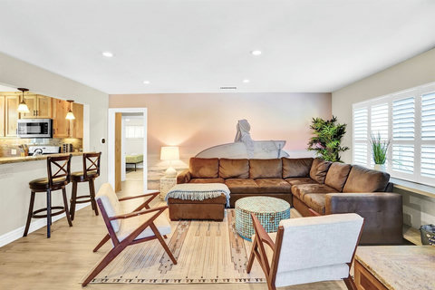 Kick back and unwind in the stylish living room, designed for ultimate relaxation with plush seating, a Smart TV, and an inviting atmosphere.