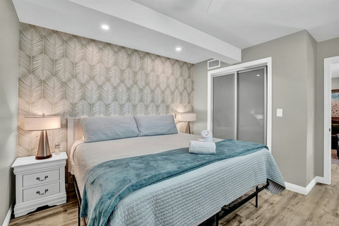 This patio-facing king bedroom is a quiet retreat, featuring a hybrid mattress, high thread-count linens, and a spacious closet
