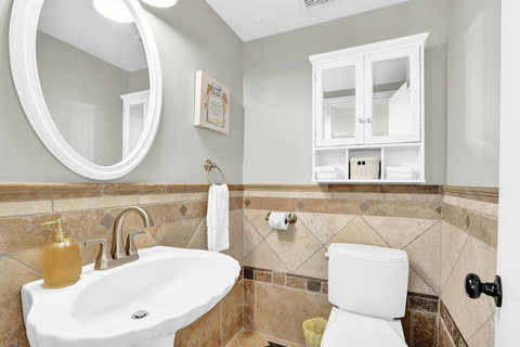 A conveniently located powder room ensures guests have easy access without disturbing the main sleeping areas.
