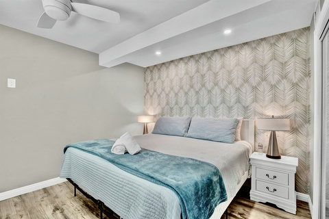 This patio-facing king bedroom is a quiet retreat, featuring a hybrid mattress, high thread-count linens, and a spacious closet