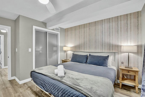 Sunlight fills this elegant king bedroom, offering the perfect blend of comfort and style.