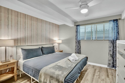 Sunlight fills this elegant king bedroom, offering the perfect blend of comfort and style.
