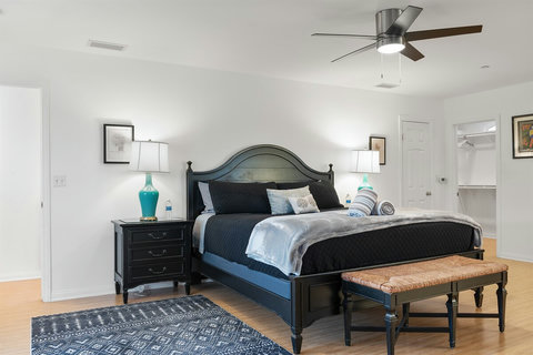 Spacious second-floor king bedroom with walk-in closet, ensuite bathroom with walk-in shower and deck