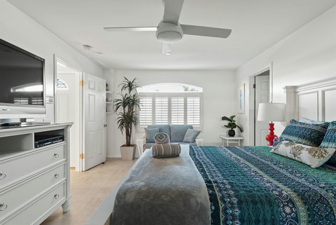 Ground-floor queen bedroom with plush bedding and cozy vibes.