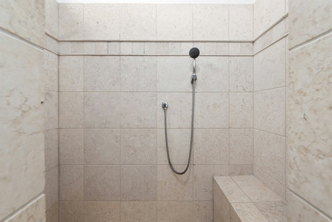 Ensuite bathroom with double sinks and walk-in shower. Essentials like shampoo, conditioner, body gel and hair dryer