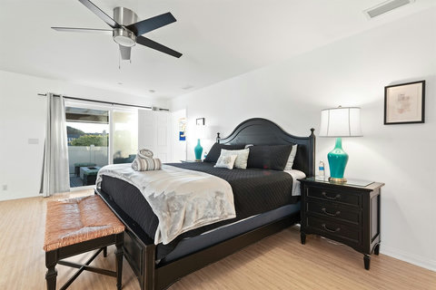 Spacious second-floor king bedroom with walk-in closet, ensuite bathroom with walk-in shower and deck