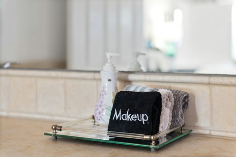 Ensuite bathroom with double sinks and walk-in shower. Essentials like shampoo, conditioner, body gel and hair dryer