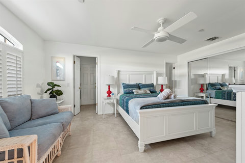 Ground-floor queen bedroom with plush bedding and cozy vibes.