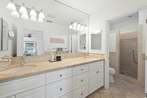 Ensuite bathroom with double sinks and walk-in shower. Essentials like shampoo, conditioner, body gel and hair dryer