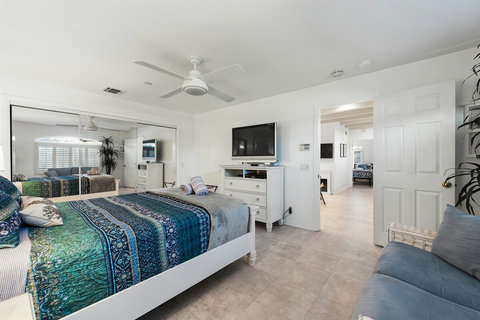 Ground-floor queen bedroom with plush bedding and cozy vibes.