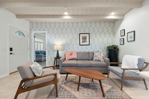 Bright and airy living room featuring a cozy sofa sleeper for extra guests.
