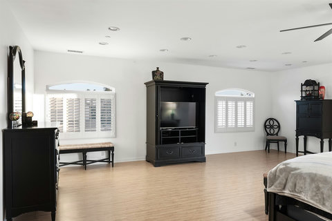 Spacious second-floor king bedroom with walk-in closet, ensuite bathroom with walk-in shower and deck