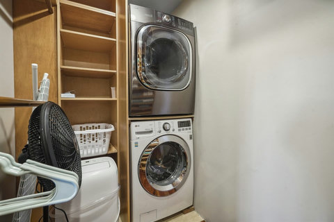 Custom walk-in closet with stacked washer/dryer and room for all your beachwear.  Addition washer and dryer is on the ground floor. 