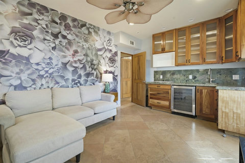 Downstairs family room with a beverage fridge and microwave makes BBQ prep and beach snacks a breeze.