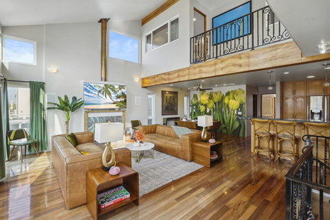 Living room features peekaboo views up to the third story—airy and inviting.