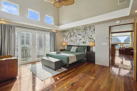 Primary King bedroom on the second floor with its own private balcony.