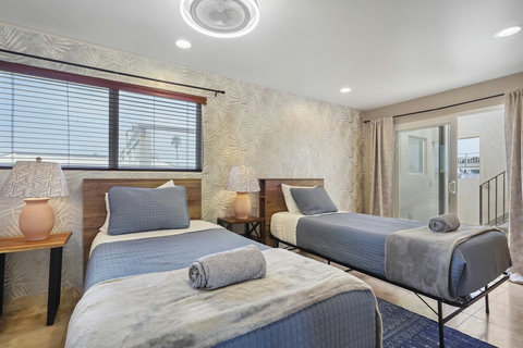 Third bedroom includes a Queen bed plus two twin beds—a versatile setup for all ages.