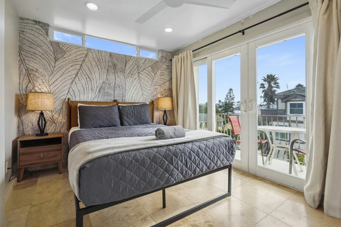 Queen bedroom with its own balcony and access to the shared bath—cozy and convenient.
