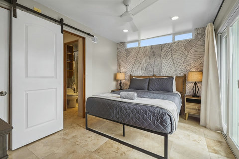 Stylish barn door provides access to the shared bathroom.