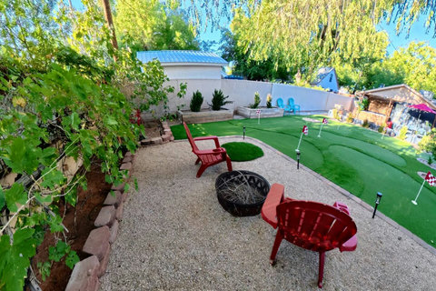 An elevated take on backyard leisure: putting green by day, fire pit by night.