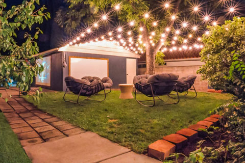 Backyard goals: hot tub, private putting green, string lights, and movies for the whole crew.