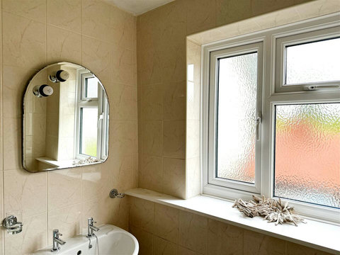 Bathroom with bath, shower, sink, WC, and heated radiator.