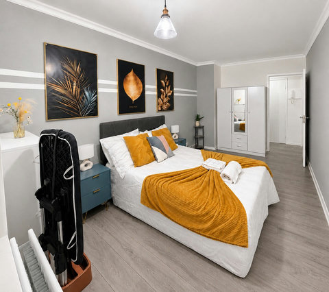 Spacious bedroom with a comfortable double bed, fresh linen, wardrobe storage and room-darkening blind for a restful stay.