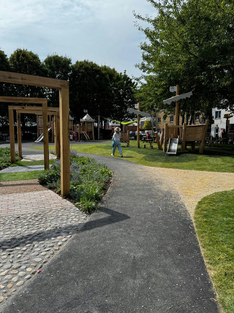 Landscaped children’s play area beside the building, offering a convenient outdoor space for families with young children.