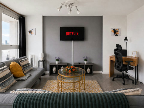 Comfortable living area with Smart TV, dedicated workspace and direct access to the private balcony.