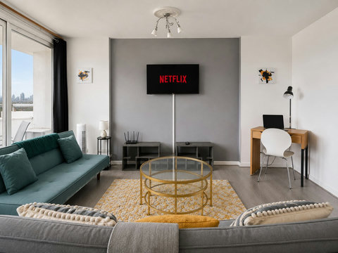 Comfortable living area with Smart TV, dedicated workspace and direct access to the private balcony.