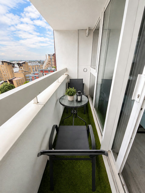 Private balcony with outdoor seating and open city views — ideal for morning coffee or relaxing after a day in London.